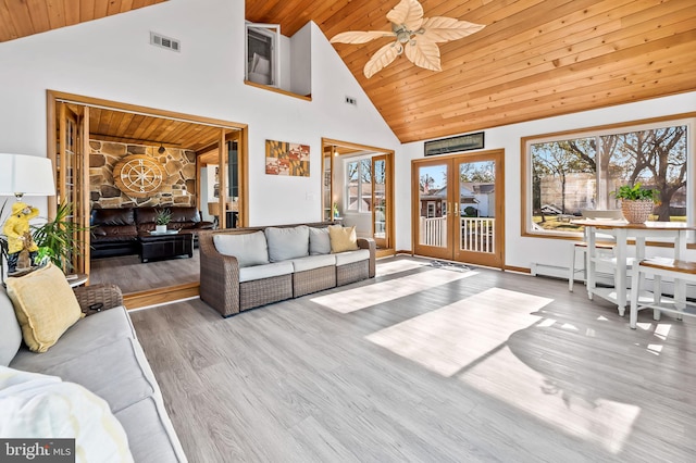 living room featuring hardwood / wood-style floors, high vaulted ceiling, french doors, and wooden ceiling