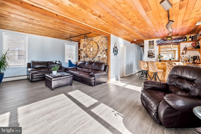 living room featuring rail lighting, hardwood / wood-style flooring, baseboard heating, and wood ceiling