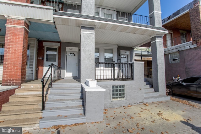 view of exterior entry with a porch