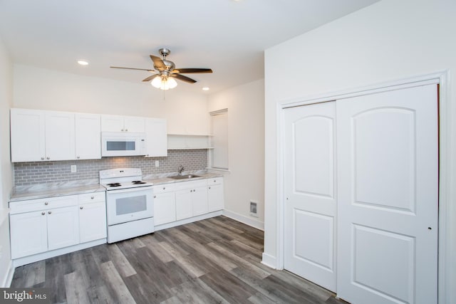 kitchen with white appliances, backsplash, sink, dark hardwood / wood-style flooring, and white cabinetry