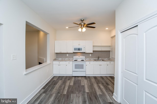 kitchen with white appliances, white cabinets, sink, tasteful backsplash, and dark hardwood / wood-style flooring