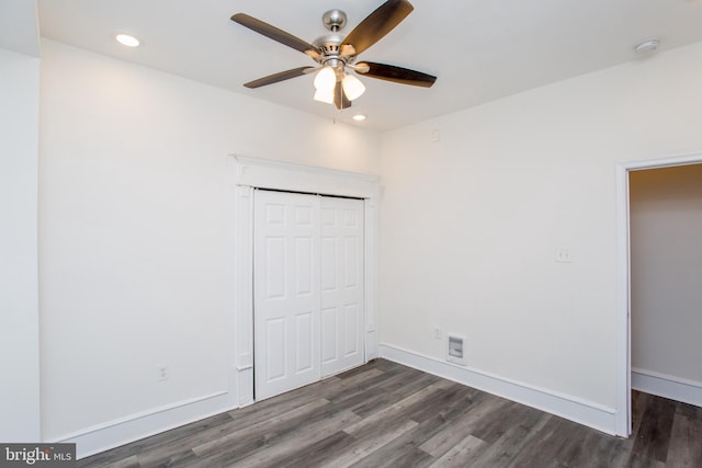 unfurnished bedroom with ceiling fan, a closet, and dark hardwood / wood-style floors