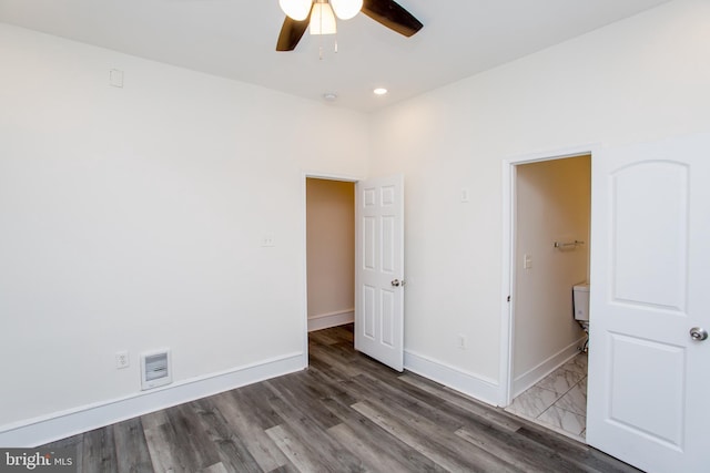 unfurnished bedroom with dark hardwood / wood-style floors and ceiling fan