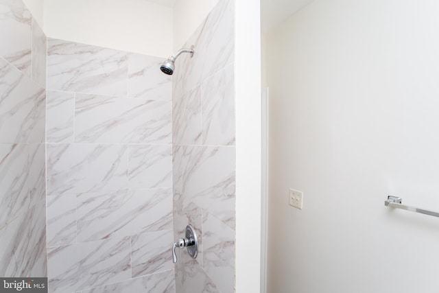 bathroom with tiled shower