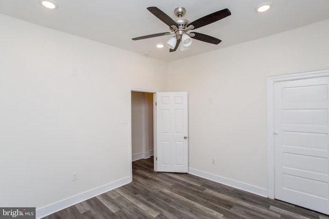 unfurnished bedroom with ceiling fan and dark hardwood / wood-style flooring