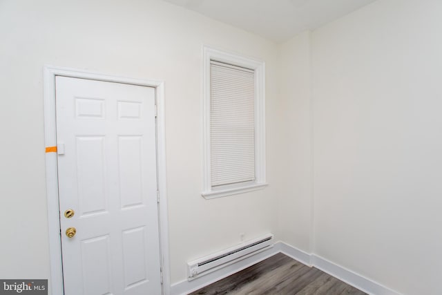 interior space with baseboard heating and dark hardwood / wood-style flooring