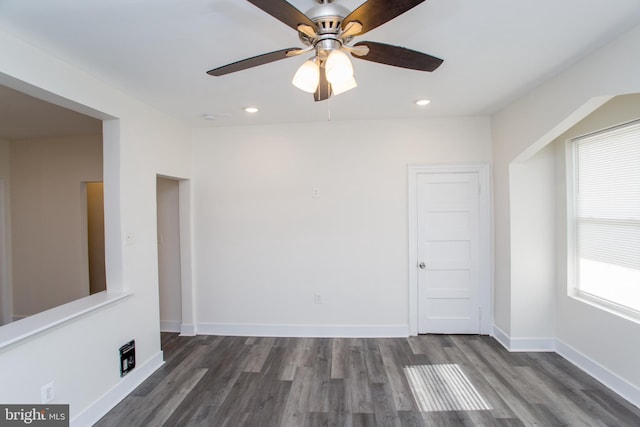 unfurnished room featuring ceiling fan and dark wood-type flooring