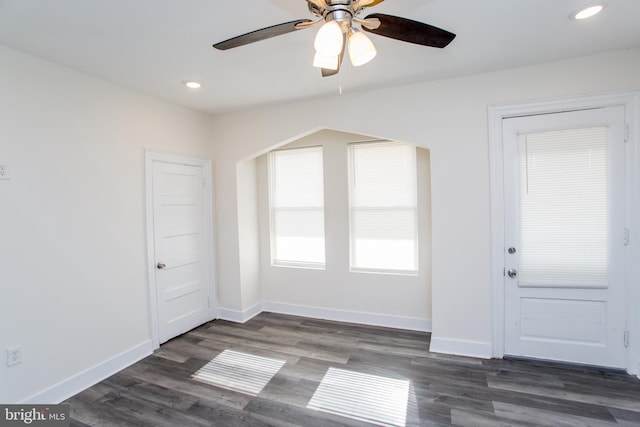 interior space with ceiling fan and dark hardwood / wood-style floors