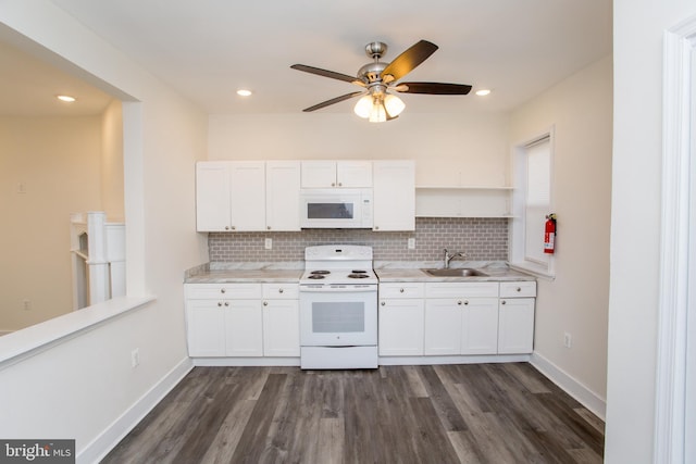 kitchen with white cabinets, white appliances, dark hardwood / wood-style floors, and sink