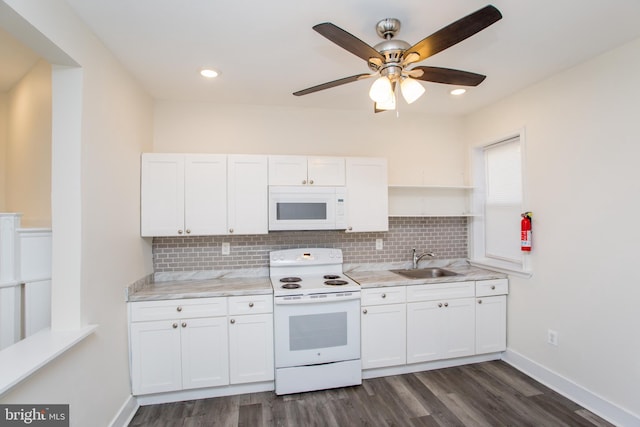 kitchen with white cabinets, white appliances, and sink