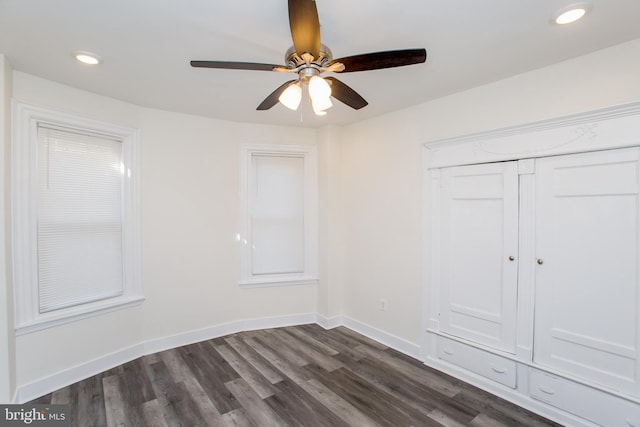 spare room with ceiling fan and dark wood-type flooring