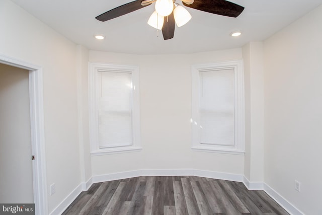 unfurnished room featuring ceiling fan and dark wood-type flooring