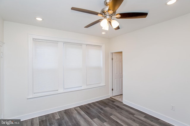 unfurnished room featuring dark hardwood / wood-style floors and ceiling fan