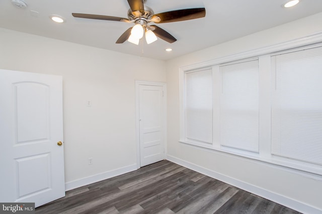 spare room with dark hardwood / wood-style floors and ceiling fan