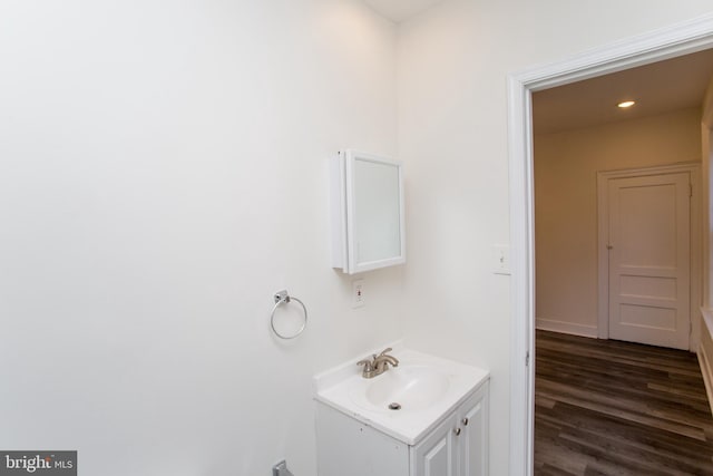 bathroom with vanity and hardwood / wood-style flooring