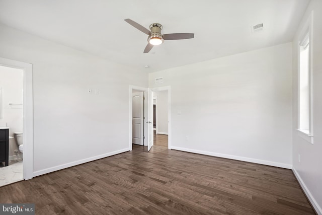 unfurnished room with dark hardwood / wood-style floors and ceiling fan