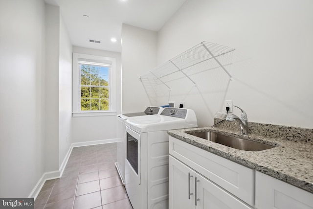 laundry area featuring sink, light tile patterned flooring, and washer and dryer