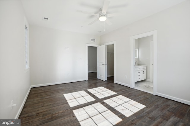 unfurnished bedroom with ensuite bath, ceiling fan, sink, dark hardwood / wood-style floors, and a closet