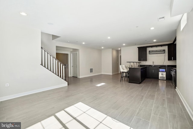 living room with light hardwood / wood-style floors and sink