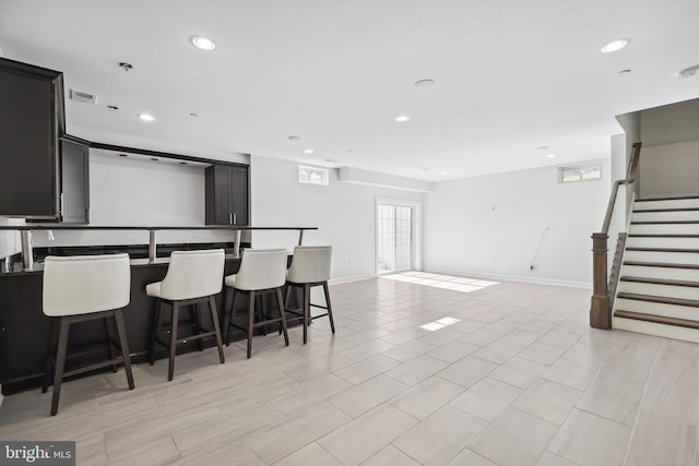 kitchen featuring a center island with sink and a breakfast bar area