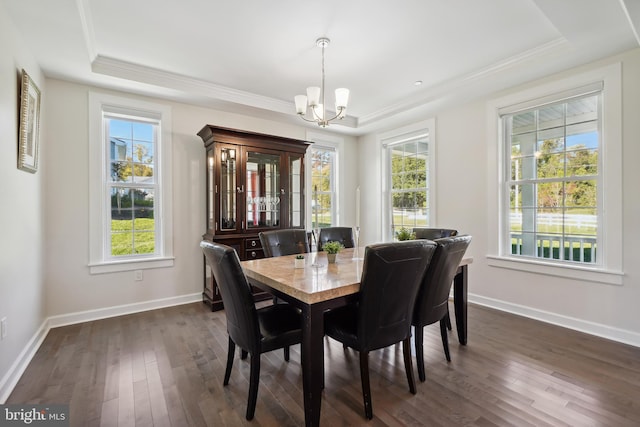 dining space featuring dark hardwood / wood-style floors, a wealth of natural light, and a chandelier