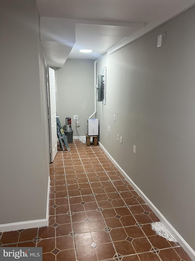 basement featuring dark tile patterned flooring