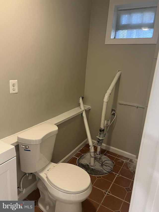 bathroom featuring tile patterned floors, vanity, and toilet