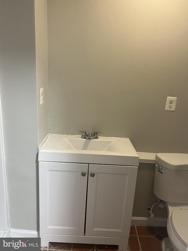 bathroom featuring tile patterned floors, vanity, and toilet