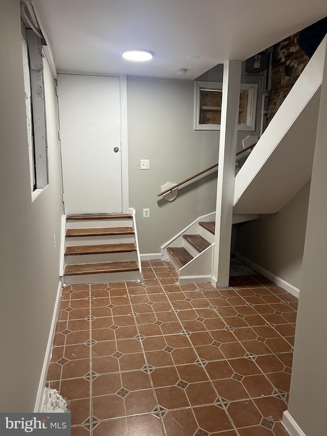 staircase featuring tile patterned flooring