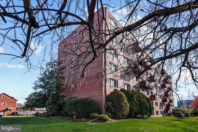 view of side of home featuring a yard