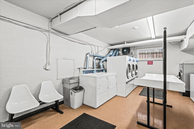 clothes washing area featuring washer and clothes dryer