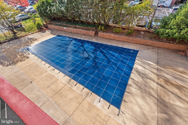 view of swimming pool featuring tennis court