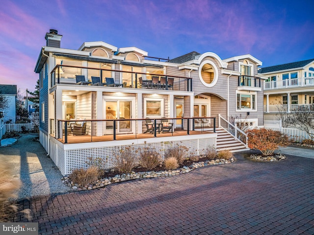 view of front of house with a balcony