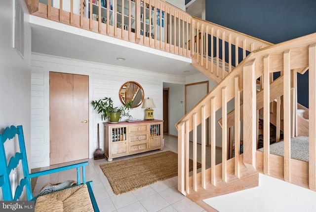 tiled foyer with wood walls