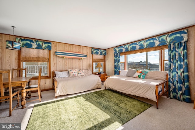 bedroom featuring carpet flooring and wooden walls