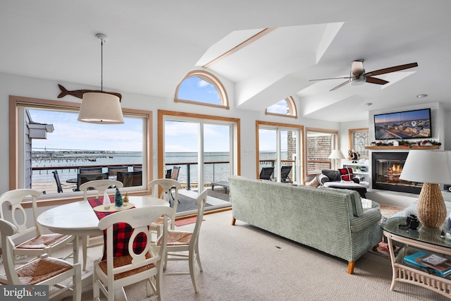 carpeted living room featuring ceiling fan and lofted ceiling