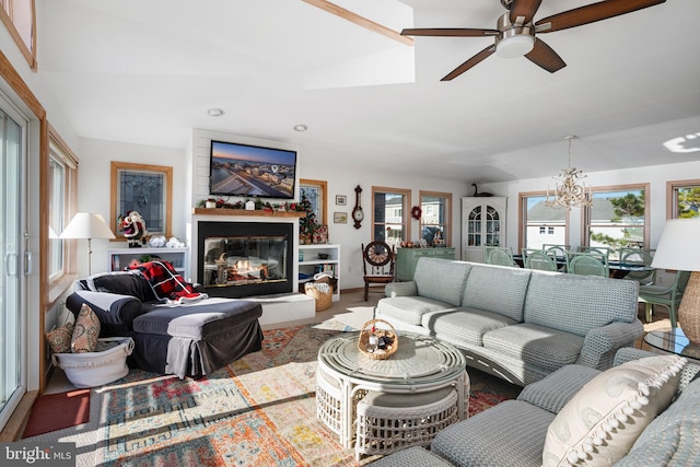 living room featuring ceiling fan with notable chandelier