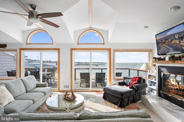 living room with ceiling fan, carpet, and vaulted ceiling