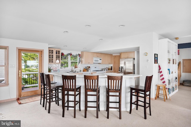 carpeted dining area with sink