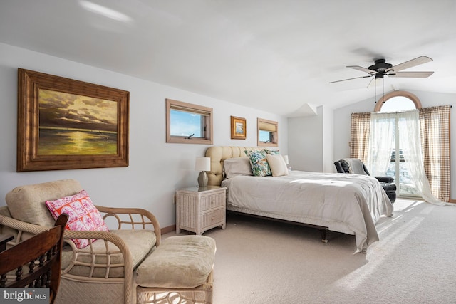 carpeted bedroom with multiple windows, ceiling fan, vaulted ceiling, and access to exterior