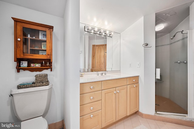 bathroom with tile patterned flooring, vanity, toilet, and a shower with door