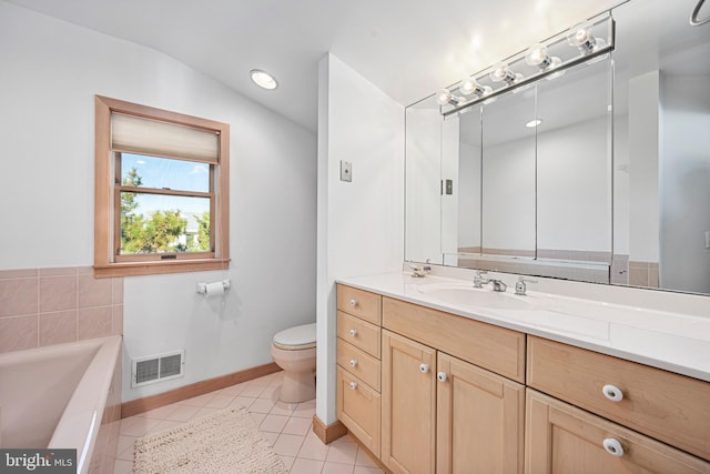 bathroom featuring a bathing tub, tile patterned flooring, vanity, and toilet