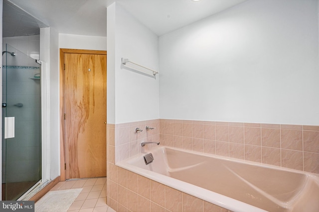 bathroom featuring tile patterned flooring and separate shower and tub