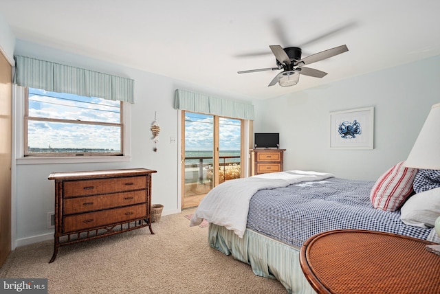 carpeted bedroom featuring ceiling fan and multiple windows