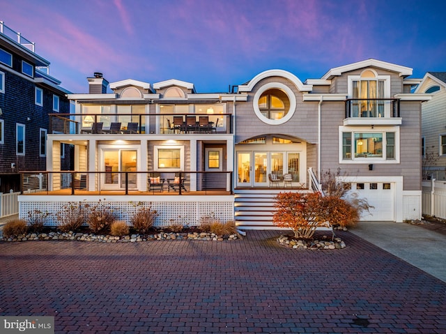 view of front facade featuring a balcony and a garage