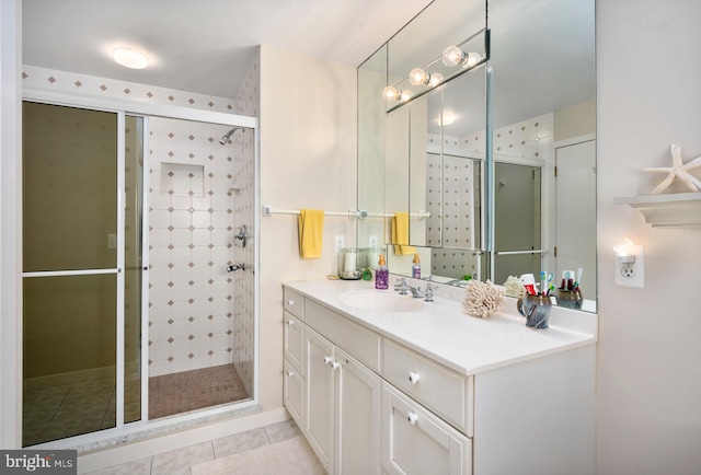 bathroom featuring tile patterned flooring, vanity, and walk in shower