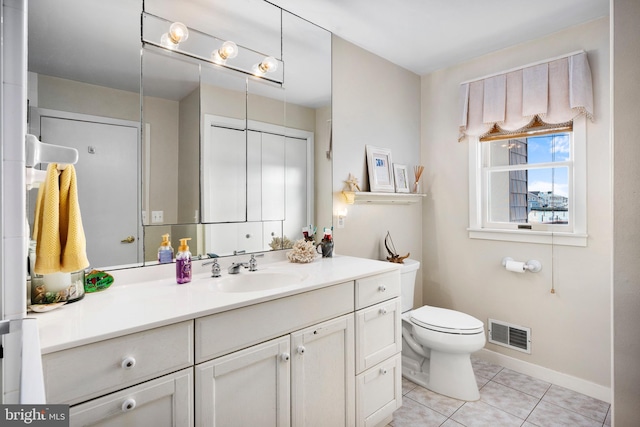 bathroom featuring tile patterned floors, vanity, and toilet