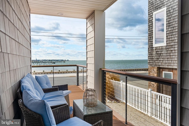 balcony featuring outdoor lounge area and a water view