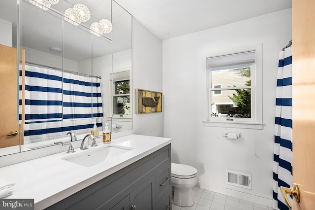 bathroom featuring tile patterned flooring, vanity, and toilet