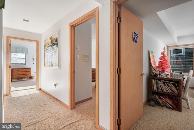 hall with light colored carpet